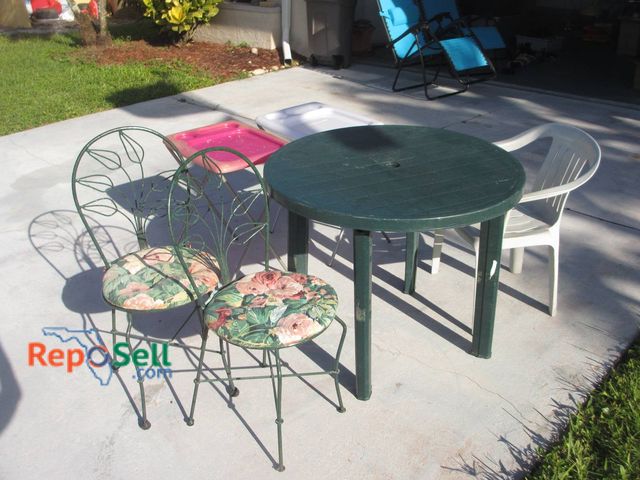 Lot 31-8580 - Outdoor Patio Lot: Table, 2 Metal Chairs, Plastic Chair, and 2 Trays
