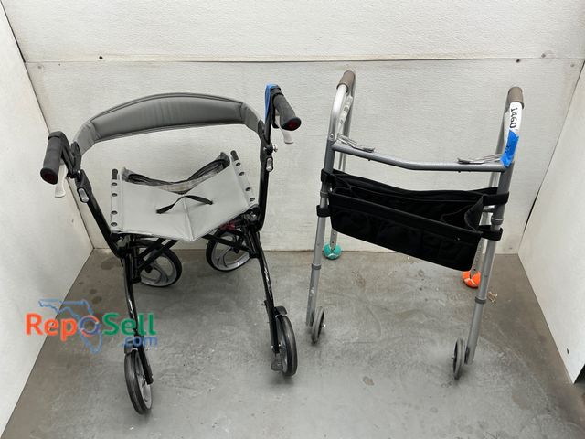 Lot 31-1460 - Includes a folding rollator chair with grey cushioned seat, black metal frame, storage pouch, and fo...