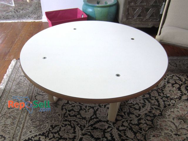 Lot 31-9226 - Knoll Furniture coffee table featuring a 36-inch round white laminate top with a contrasting plywood...