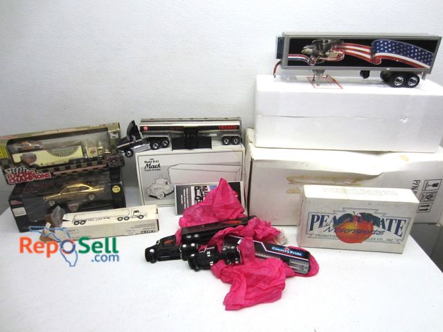 Lot 31-1078 - Lot of Die Cast Collectibles: semis, racing champs, etc.  with tote