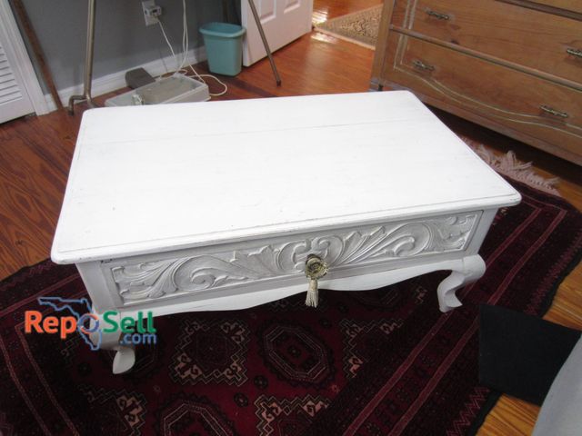 Lot 31-9029 - White Wooden Coffee Table With Detailed Carvings And Single Drawer
