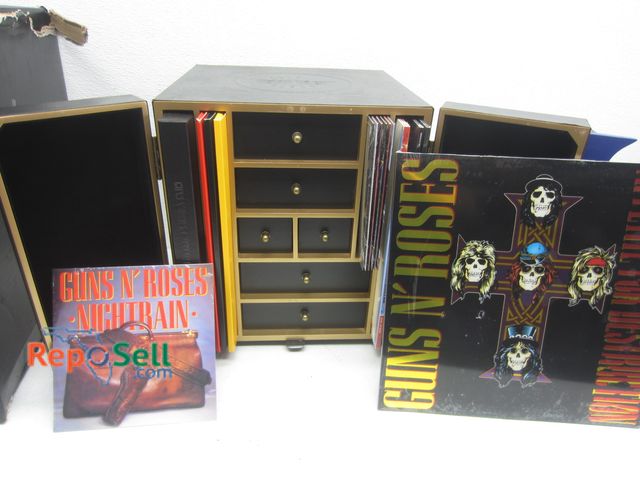 Lot 31-9141 - Guns N' Roses Collector's Box with Albums, Skull Rings, etc. - Many Items still Sealed - 14" x 12"