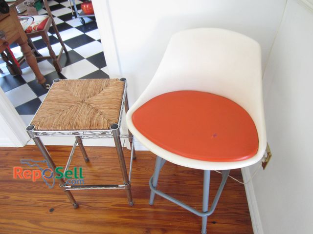 Lot 31-9118 - A Metal Stool With A Woven Seat And A White Plastic Stool With Orange Cushion.