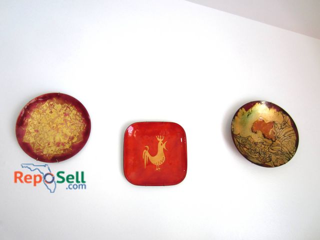 Lot 31-9119 - Three Decorative Enamel Plates In Red And Gold Tones, Including Rooster And Abstract Motifs.