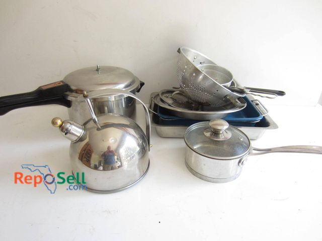 Lot 31-9178 - A variety of stainless steel cookware and utensils. Items include a Revere Ware pressure cooker with...