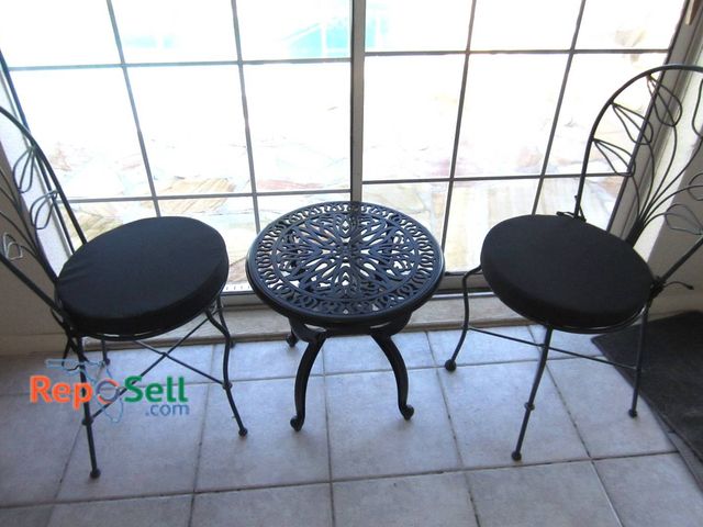 Lot 31-8608 - Small Metal Bistro Set With Table And Two Decorative Chairs