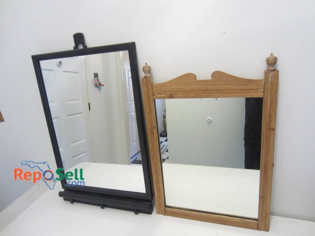 Lot 31-9063 - Two Wooden Frame Mirrors, Black With Easel Stand And Natural With Finial Detailing.