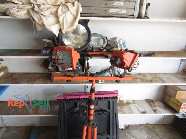 Lot 31-2056 - Contents of Shelf  and Work light, 2 saw horses, metal tool box etc