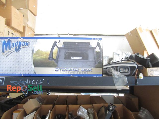 Lot 31-1165 - Contents Of Shelf Including Madjax Storage Box, Epic Icon Headlight, Fender Cap, etc.