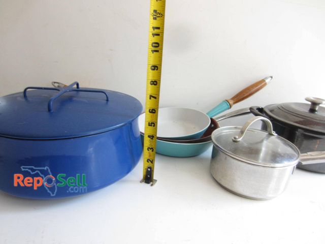 Lot 31-9184 - Cookware set featuring a blue enameled pot stamped "Dansk Designs," a turquoise skillet marked "Le C...