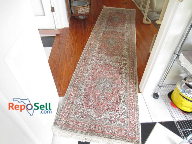 Lot 31-9317 - A Handwoven Rectangular Rug Featuring A Multicolored Floral And Geometric Pattern In Predominantly R...