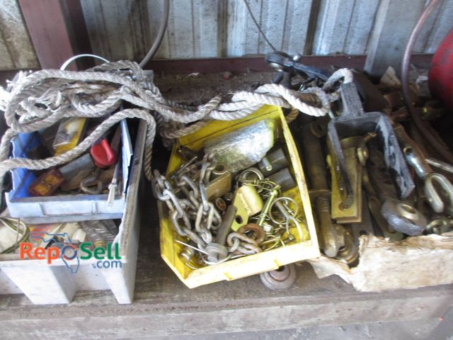 Lot 31-1310 - A Variety Of Items Stored Under A Workbench. Items Include Hydraulic Fittings, Various Chains, Ropes...