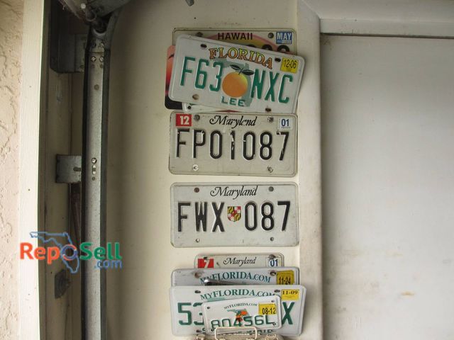 Lot 31-8379 - Vintage License Plates Attached To Wall Including Florida, Maryland And Hawaii