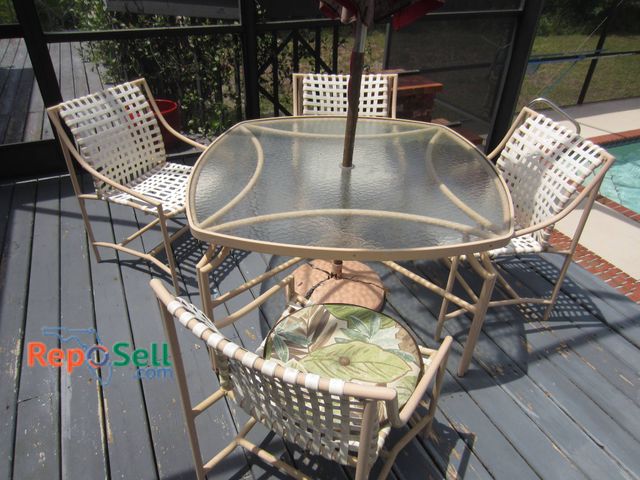 Lot 31-9222 - Outdoor patio set including a triangular glass top table with metal frame and umbrella hole, accompa...