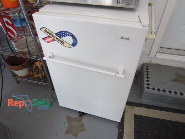 Lot 31-9136 - Kenmore Compact White Refrigerator Featuring Two Interior Wire Shelves And A Recessed Handle. Exteri...