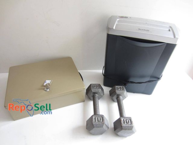 Lot 31-9314 - A beige metal lock box with a key, a black and gray paper shredder with visible controls on the top,...
