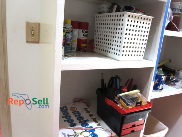 Lot 31-1338 - Contents of Left Side of Shelves: Tool Box, Tape Guns, Velcro, etc.