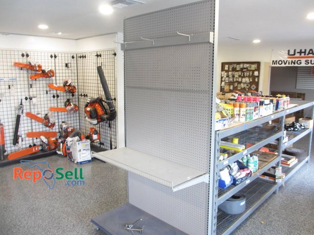 Lot 31-1331 - Retail end cap featuring an 8ft x 4ft steel structure NO Contents -pegboard backing, adjustable shel...