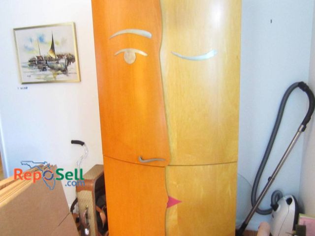 Lot 31-9236 - Designer Wooden cabinet (No Contents) *Please schedule pick up after 12pm* featuring a unique face d...