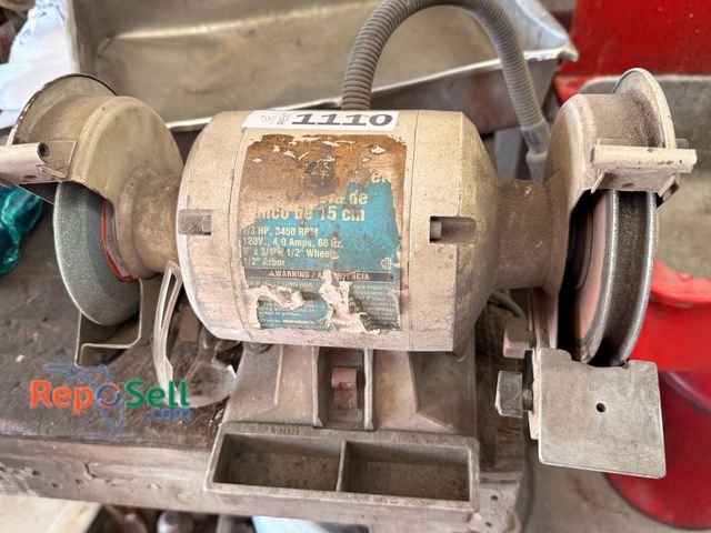 Lot 31-1110 - Heavy-Duty Bench Grinder Featuring Dual Grinding Wheels And A Central Motor Unit.