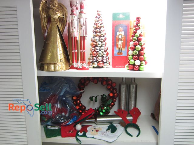 Lot 31-1431 - (2) Shelves Of Christmas Decor: Bell Wreath, Towels, Hats, Metal Angel, Nutcracker etc