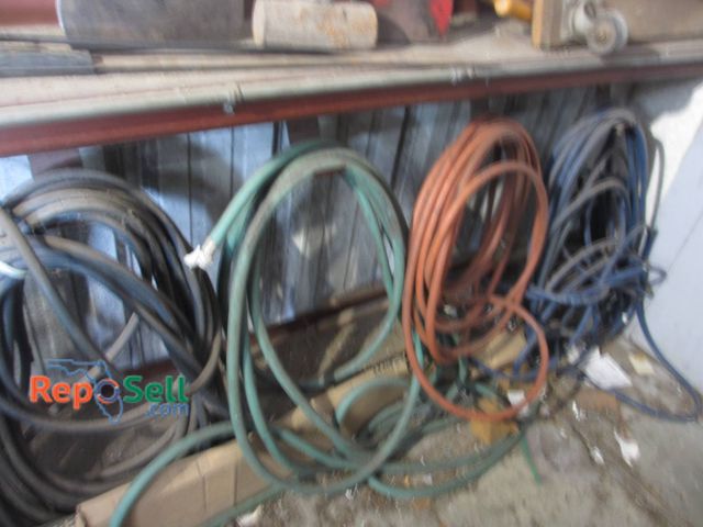 Lot 31-1317 - Multiple hoses in assorted colors, including green, red, blue, and black. Hoses appear coiled and ar...