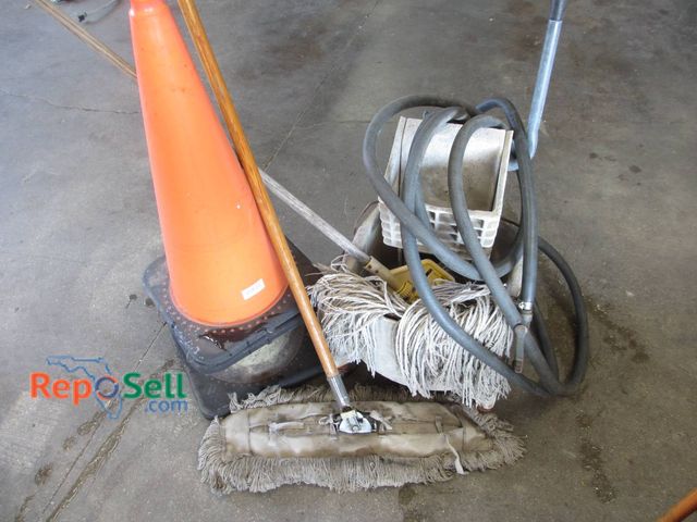 Lot 31-1306 - (3) Orange Safety Cones With Black Bases, A Mop Bucket With Attached Wringer, Multiple Mops, And A C...