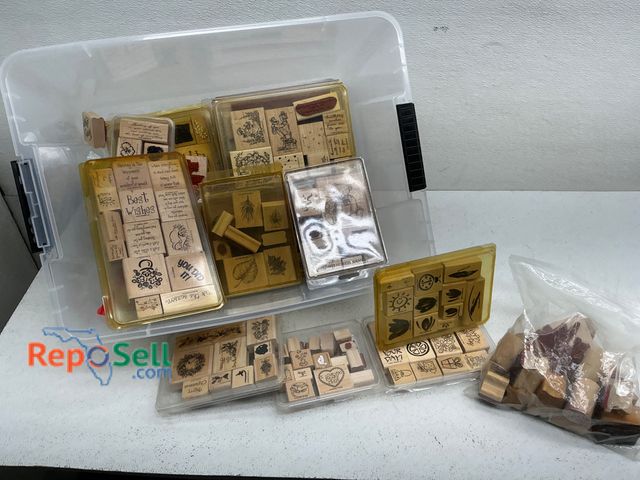Lot 31-1413 - Various rubber stamps with wooden handles, stored in plastic containers and clear trays. Stamps feat...