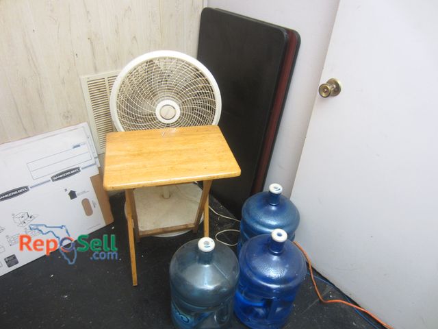 Lot 31-2124 - Estate Lot: Lasko Fan, (3) 5gal Jugs, Folding Table, (2) Table Tops 42" x 24