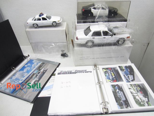 Lot 31-1313 - (7) Die-Cast police cars with decal templates on paper and 64 quart tote