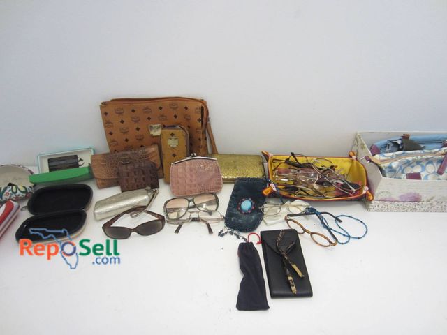 Lot 31-9090 - Ladies Wallets, Prescription Eyeglasses, Cosmetic Bags: MCM Bags, Coach Keychain, etc. Authenticity ...