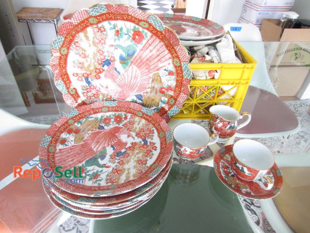 Lot 31-9192 - Arita fine china dinnerware set made in Japan, featuring a multi-colored peacock and floral motif on...
