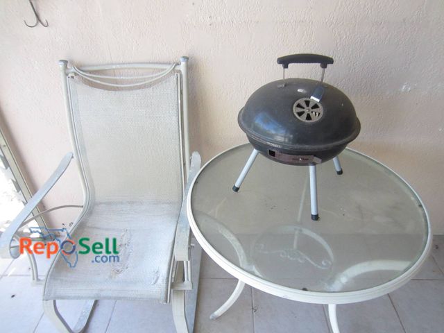 Lot 31-8605 - Portable Charcoal Grill With Patio Table And Mesh Chair