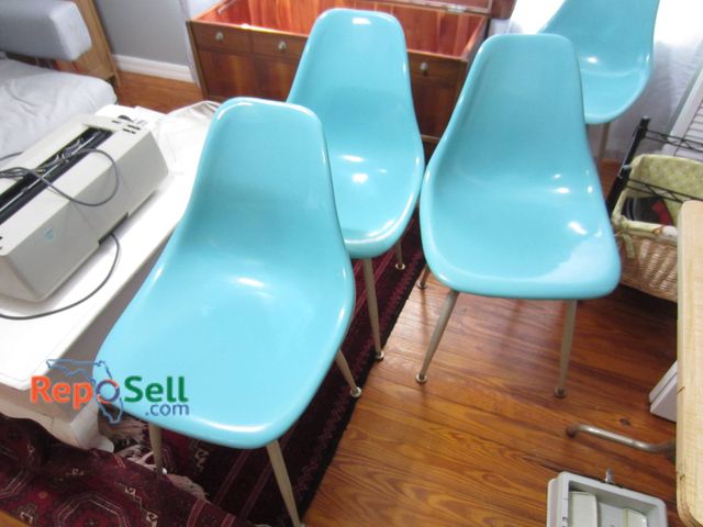 Lot 31-9022 - Four Aqua-Molded Plastic Chairs Featuring Metal Legs
