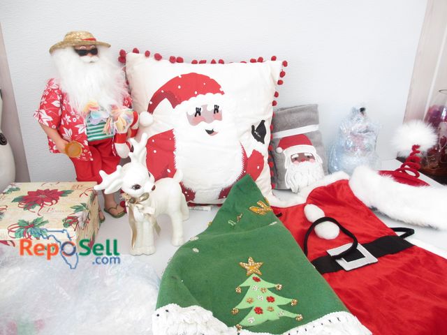 Lot 31-2183 - Christmas Decor: Ceramic Reindeer, Santa Apron, Plastic Beach Santa, etc.