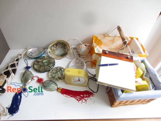 Lot 31-9249 - A group of assorted decorative items, including abalone shell art pieces, a small electric cream-col...