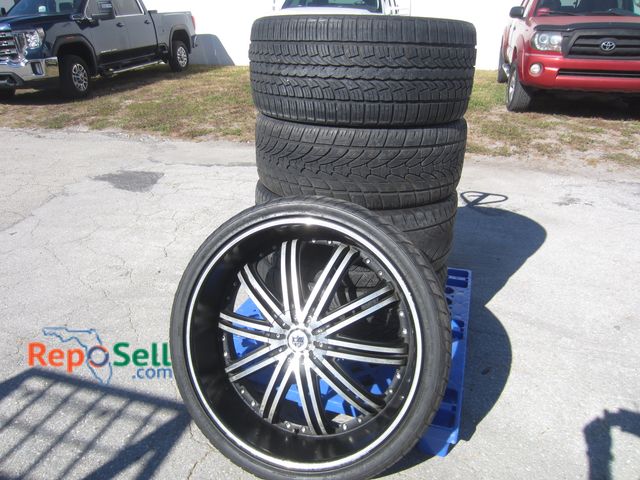 Lot 31-9352 - (4) 26" Rims and Tires 305-30ZR26 and (1) Tire without Rim - One tire not holding air, One rim dente...