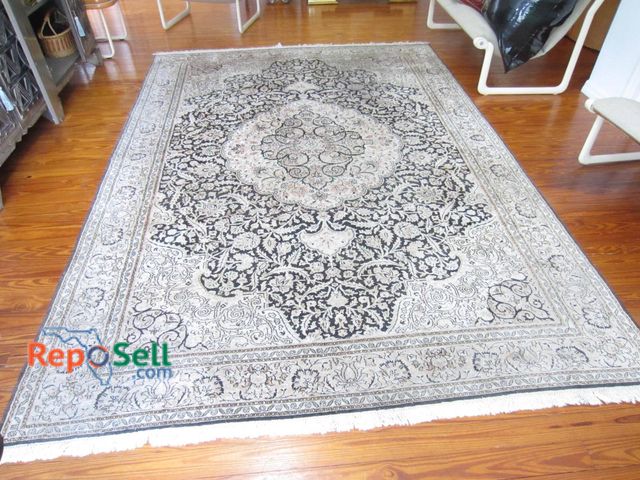 Lot 31-9318 - Large area rug featuring a central floral medallion pattern in contrasting shades of black and off-w...