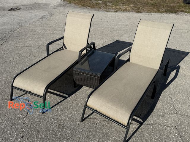 Lot 31-9550 - (2) Metal Lounge Patio Chairs and Side table