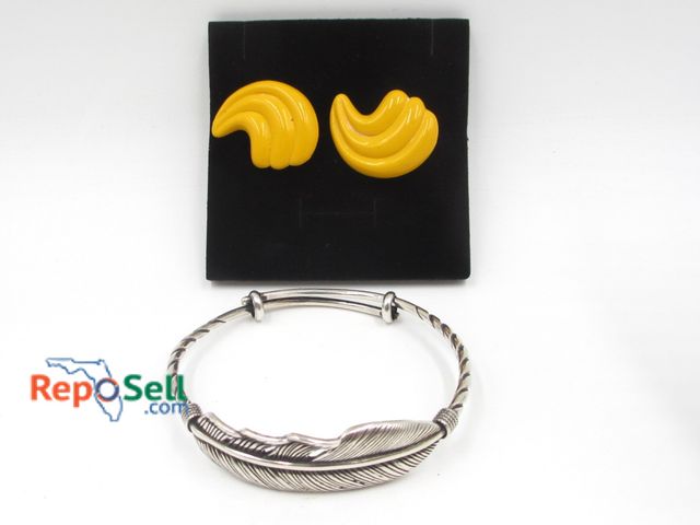 Lot 31-6007 - Vintage Bakelite butterscotch clip earrings and metal feather bracelet.