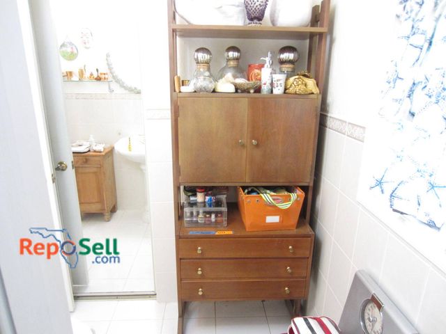 Lot 31-9324 - Wooden storage unit NO Contents:  *Please schedule pick up after 12pm* featuring three bottom drawer...