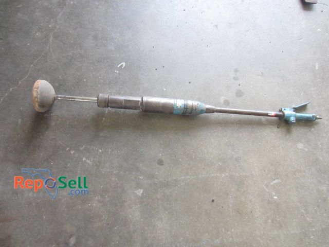 Lot 31-1356 - Pneumatic tamper featuring a blue metal housing with visible wear. The tool includes a compression f...
