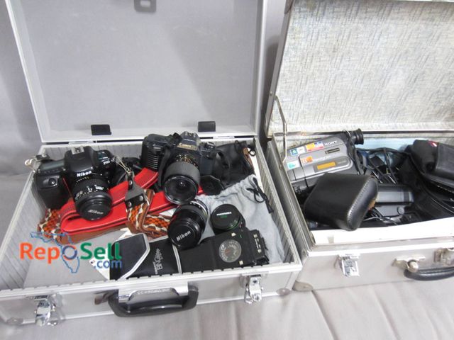 Lot 31-9017 - Includes Nikon F50, Canon T50, Sony Camcorder, Various Lenses, Cases, And Accessories. Not Tested
