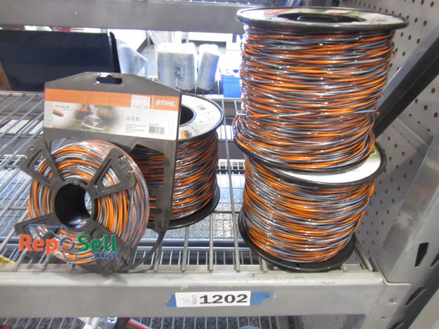 Lot 31-1202 - New Stihl trimmer line lot: three large rolls, one small, some hardware.