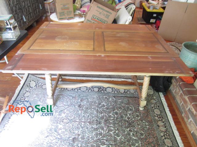 Lot 31-9127 - Wood dining table with turned legs, decorative side detailing, has a center leaf and an estimated si...