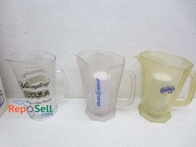 Lot 31-3508 - (13) Vintage Beer Pitchers: Miller, Yuengling, Bug Light, etc.