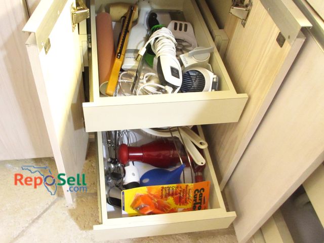 Lot 31-1179 - Contents Of Cupboard: Knife Sharpener, Kitchen Utensils, Hand Blender, Strainers etc