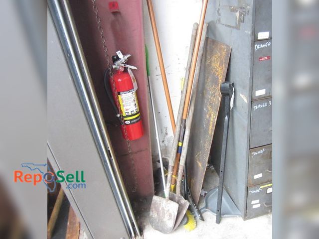 Lot 31-1290 - Tool Lot In Corner: Shovels, Rear Strut Bar, Metal Sheet, Fire Extinguisher, etc