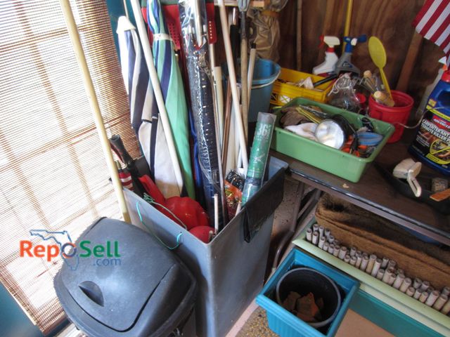 Lot 31-9219 - Contents Of Corner With Yard Tools And AccessoriesÂ A folding table, multiple yard tools stored in a...