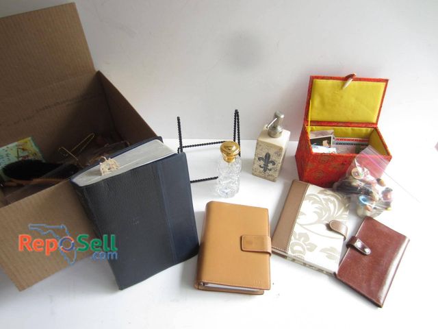 Lot 31-9306 - Desk items and small accessories. Items pictured include multiple journals and planners in leather o...